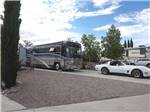 Motorhome and Corvette parked in a RV site at ELEPHANT BUTTE LAKE RV RESORT - thumbnail