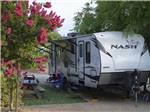Trailer parked in a shady site at ANGELS CAMP RV RESORT - thumbnail