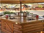 Outdoor bar with cabins in the background at ANGELS CAMP RV RESORT - thumbnail