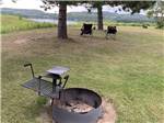 A fire pit and chairs overlooking the water at SHERWOOD FOREST CAMPGROUND - thumbnail