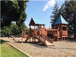 Sand playground with wooden swing set at COEUR D'ALENE RV RESORT - thumbnail