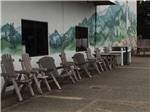 Rustic chairs outside of the registration building at PACIFIC PINES RV PARK & STORAGE - thumbnail