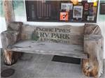 A rustic driftwood bench at PACIFIC PINES RV PARK & STORAGE - thumbnail