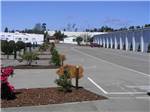 A row of RV sites and the indoor RV storage at PACIFIC PINES RV PARK & STORAGE - thumbnail
