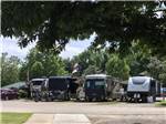 RVs parked in a few of the sites at OUTDOOR LIVING CENTER RV PARK - thumbnail