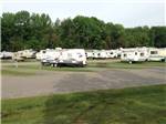RVs parked at campground at OUTDOOR LIVING CENTER RV PARK - thumbnail