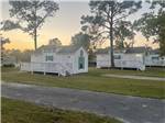 A row of the rental cabins at GULF BREEZE RV RESORT - thumbnail