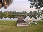 The wooden dock with chairs at GULF BREEZE RV RESORT - thumbnail