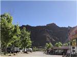 RV park entrance sign with large mountain in background at SPANISH TRAIL RV PARK - thumbnail