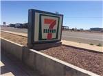 A seven-eleven sign next to the road at BLANDING RV PARK - thumbnail