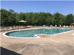 Swimming pool with outdoor seating at THE VILLAGES AT TURNING STONE RV PARK - thumbnail