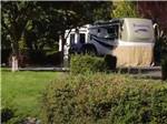A fifth wheel trailer next to grass at VICTORIAN RV PARK - thumbnail