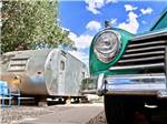 The front of a car parked next to a trailer at ENCHANTED TRAILS RV PARK & TRADING POST - thumbnail