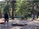 A family playing horseshoes at WHISPERING PINES RV CAMPGROUND - thumbnail