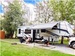 People relaxing outside their RV at CREEKSIDE RV PARK - thumbnail