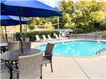 Outdoor furniture surrounding the pool at CREEKSIDE RV PARK - thumbnail