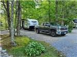 A truck and trailer in a gravel RV site at SMOKY BEAR CAMPGROUND AND RV PARK - thumbnail