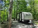An RV backed in a gravel site at SMOKY BEAR CAMPGROUND AND RV PARK - thumbnail