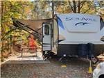 A Solaire trailer parked in a RV site next to a picnic bench at SMOKY BEAR CAMPGROUND AND RV PARK - thumbnail