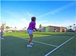 Couples playing tennis at APACHE WELLS RV RESORT - thumbnail