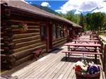 Lodging with deck and picnic tables at ELK MEADOW LODGE AND RV RESORT - thumbnail