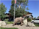 A bear figurine with rocks at YELLOWSTONE GRIZZLY RV PARK - thumbnail