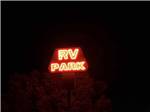 The lit up red neon main entrance sign at ELKO RV PARK - thumbnail