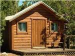 Cabin with door, windows and porch at TURQUOISE TRAIL CAMPGROUND & RV PARK - thumbnail