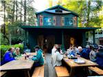 People dining at long tables at RIVER BEND RESORT - thumbnail