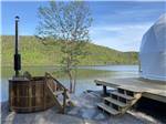 A wood fired hot tub next to the glamping dome rental at GROS MORNE/NORRIS POINT KOA - thumbnail