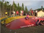 A group of kids on the jumping pillow at GROS MORNE/NORRIS POINT KOA - thumbnail