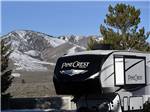 A fifth wheel trailer parked with mountain in the background at BORDERTOWN CASINO & RV RESORT - thumbnail