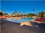 The large swimming pool with red lounge chairs at PUEBLO EL MIRAGE RV & GOLF RESORT - thumbnail