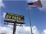 The front entrance sign and American flag at STONE CREEK RV PARK - thumbnail
