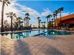 Pool outside main building, with palm trees in background at GOLD CANYON RV & GOLF RESORT - thumbnail