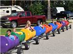 Kids on a train made of 55 gallon drums at VACATION STATION RV RESORT - thumbnail