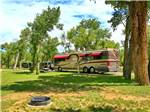 A Class A motorhome parked in an RV site at THE LONGHORN RANCH LODGE AND RV RESORT - thumbnail