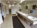 Public bathroom with five sinks at NINETY-9 RV PARK - thumbnail
