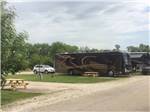 Open RV site next to parked motorhomes at RV PARK AT HOLLYWOOD CASINO JOLIET - thumbnail