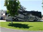 Black, white and grey motorhome parked at A COUNTRY RV PARK - thumbnail