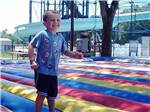Boy smiling on jump pad at RAGANS FAMILY CAMPGROUND - thumbnail