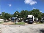 Airstream and fifth-wheel in neighboring sites at WOODLAND LAKES RV PARK - thumbnail
