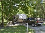 Dodge Ram truck parked in front of a fifth wheel trailer at MILLER'S CAMPING RESORT - thumbnail