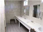 Row of sinks in public bathroom at COUNTRY ROADS RV PARK - thumbnail
