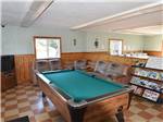 The pool table with games and magazines on the rack at COUNTRY ROADS RV PARK - thumbnail