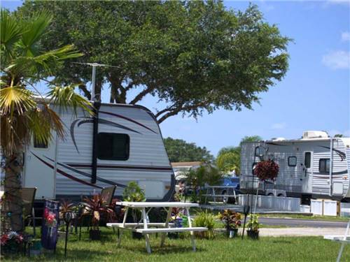 A camper adds personal flair to an RV spot at KISSIMMEE RV PARK