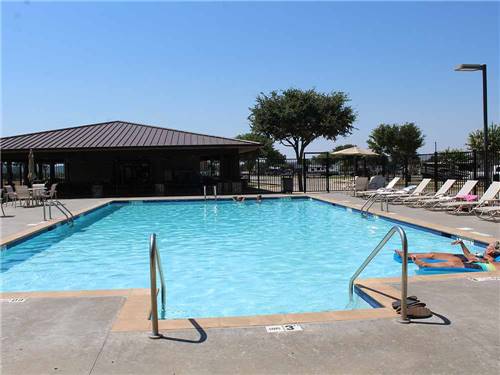 Swimming pool with lounge chairs at FUN TOWN RV PARK AT WINSTAR