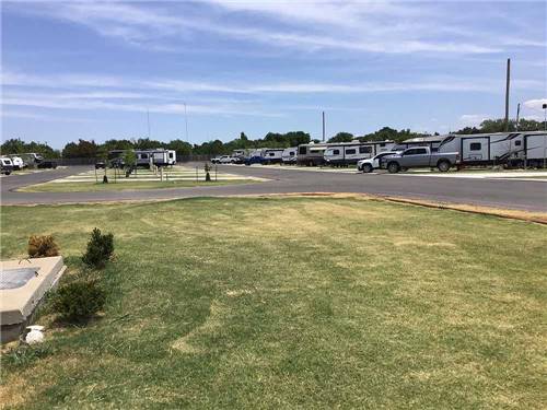 A row of travel trailers in RV sites at BUFFALO BOB'S RV PARK