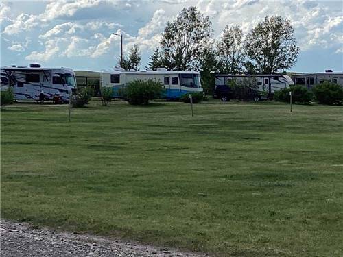 Sprawling lawn abuts RV campground at SLEEPING WOLF CAMPGROUND & RV PARK