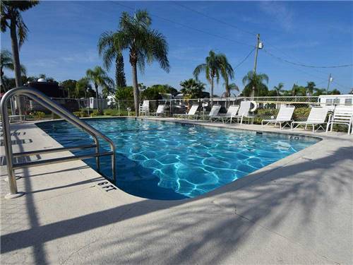 Swimming pool with outdoor seating at AVALON RV RESORT